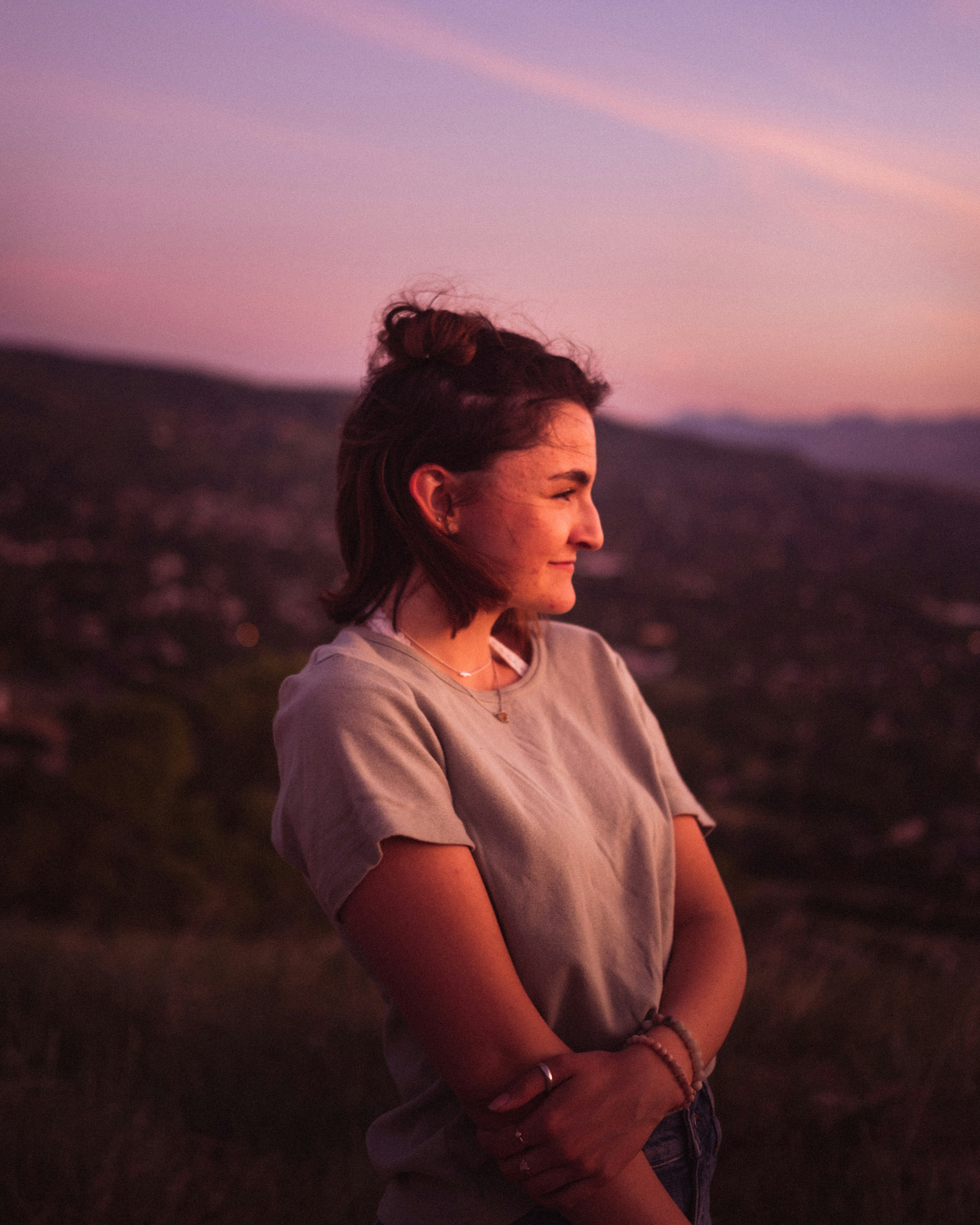 woman in white shirt standing on brown field during daytime